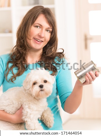 Woman Owner Of Small Doggy Maltese With Can Of Dog Food