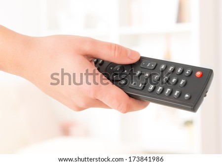 closeup of woman's hand with remote controller at home