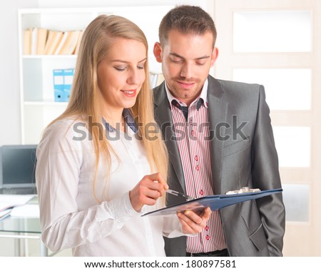 Business people reading a document together in the office