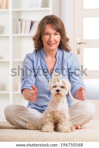 Woman doing Reiki therapy for a dog, a kind of energy medicine.