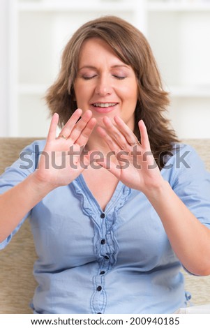 Woman practicing Reiki transfering energy through palms, a kind of energy medicine.