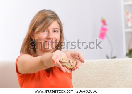 Young, smiling woman showing her new deaf aids on her hands