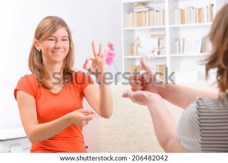 Smiling deaf woman learning sign language