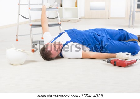 Man worker laying on a floor, concept of accident at work