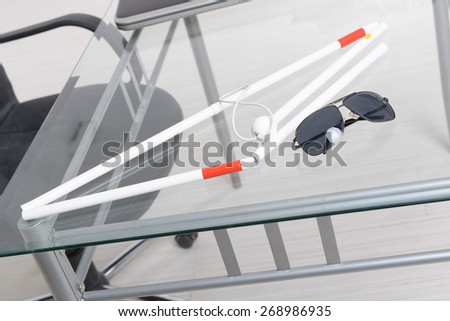 White stick and dark glasses for blind person