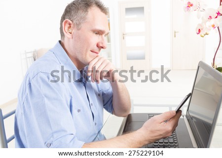 Hearing impaired man working with laptop and mobile phone at home or office