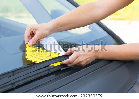 Parking ticket placed under windshield wiper