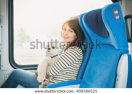 Dog traveling by train with his owner
