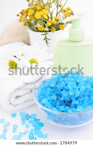 Bath salt in the glass with towel and flowers.