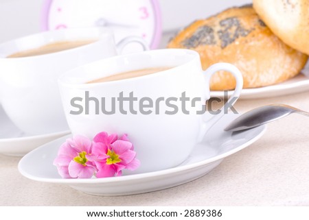 Coffee and bread with clock in the background.