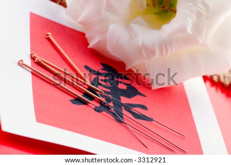 Needles for acupuncturist shown on Chinese health sign.