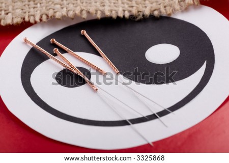 Needles for acupuncturist shown on Chinese Yin-Yang sign.