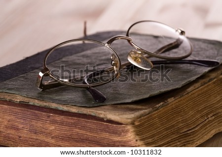 Image of very old book (AD 1902) and glasses.