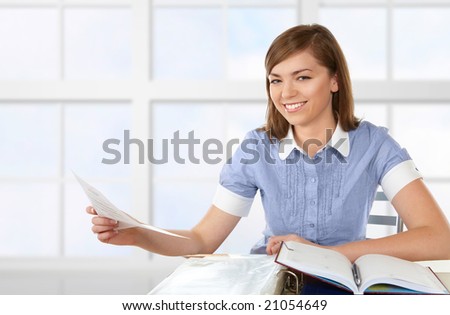 Woman in office or school or home working with papers