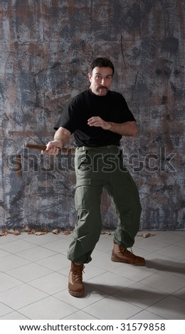 Portrait of man practice martial arts using nunchaku