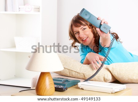 Beautiful young woman laying on the sofa with telephone headset