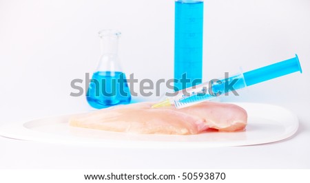Injecting GMO chicken meat. Genetically modified organism or GEO here transgenic plant is an plant whose genetic material has been altered using genetic engineering techniques