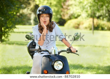 surprised woman oman riding retro motorbike scooter