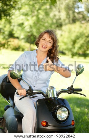 Woman ride retro motorbike scooter