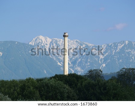 High Chimney growing out of the Trees with Mountains in the Background.