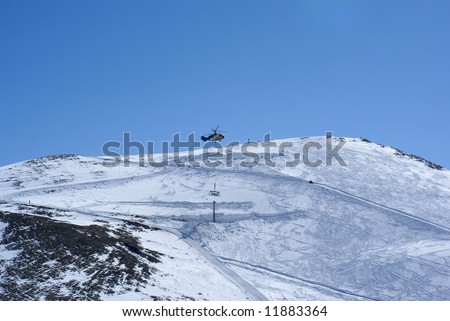 The mountain tops covered by a snow, sunny day, helicopter set holder for railway