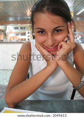 smiling girl at snack bar with elbows on the table