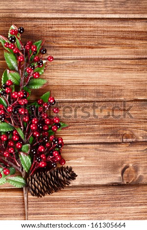 branches with Christmas berries on wooden panels