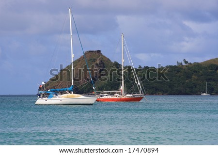 Small yachts anchored in small caribbean harbor