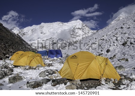 ISLAND PEAK BASE CAMP,NEPAL-APRIL 06:The colorful tents after snow at Island peak base camp on April 06,2012 in the Himalaya Everest Region,Nepal