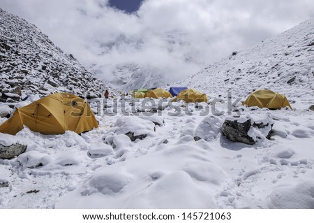 ISLAND PEAK BASE CAMP,NEPAL-APRIL 06:The colorful tents after snow at Island peak base camp on April 06,2012 in the Himalaya Everest Region,Nepal