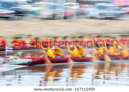 PATUMTHANI, THAILAND - OCT 28: Panning shot of two rowing teams in full speed during Long-tailed Boat Competition for Royal Championship Cup on October 28, 2012 in Rangsit, Pathumthani,Thailand.