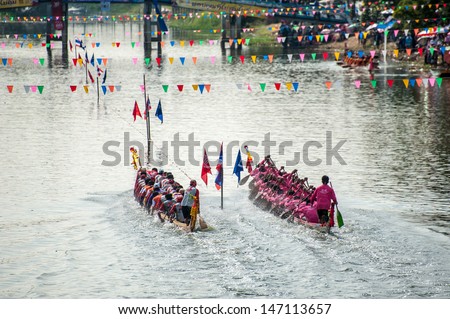 PATUMTHANI, THAILAND - OCT 28: Top view of two rowing teams in full speed during Thai Long-tailed Boat Competition for Royal Championship Cup on October 28, 2012 in Rangsit, Pathumthani,Thailand.
