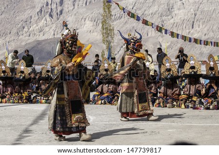 DISKIT,LADAKH,INDIA-OCTOBER 14:Traditional artists perform Cham dance(masked dance is some sects of Buddhists) during Diskit Festival at Diskit monastery on October 14, 2012 in Diskit,Ladakh, India.