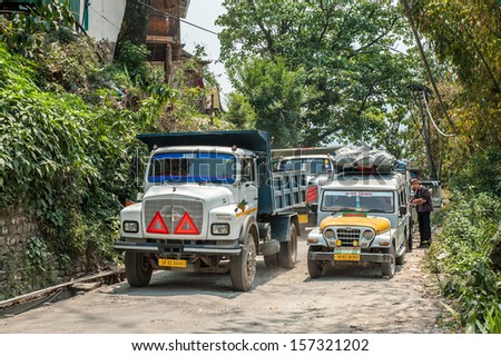 GANGTOK,SIKKIM,INDIA-APRIL 13:The India truck and tourist car in the road of Gangtok town on April 13,2013 in Sikkim,India.