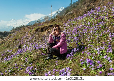 Beautiful woman relaxing in purple flower field