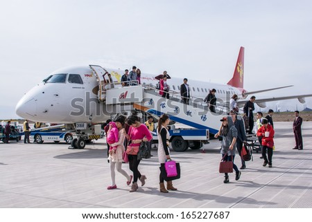 JIAYUGUAN,CHINA-OCTOBER 13:Chinese people just arrive and having left the aircraft at Jiiayuguan airport on October 13,2013 in Jiuguan,Gansu,China .
