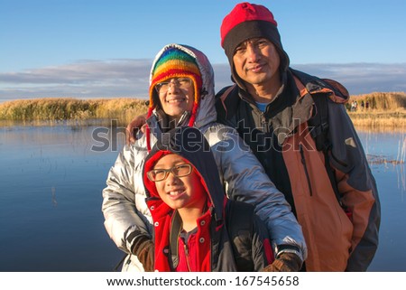 Portrait happy family with sunrise at the lake,family photo
