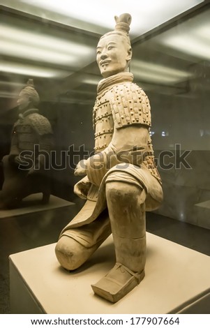 XIAN, CHINA - OCTOBER 23:The famous Chinese terracotta army figures are exhibited on October 23,2013 in Xian, China.The figures date back to 210 BC and belong to China\'s most important discoveries.