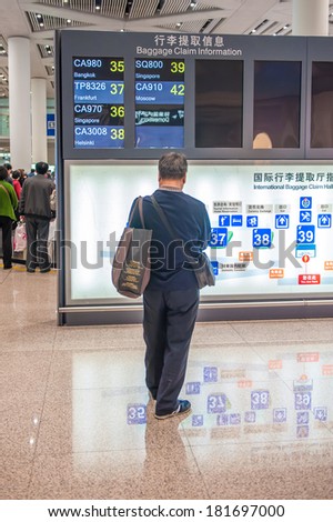 BEIJING,CHINA - MARCH 28 ,2011:Passenger at Baggage claim information in Beijing Airport Terminal 3 in Beijing,China.The airport registered 488,495 aircraft movements and as ranked 10th in the world.