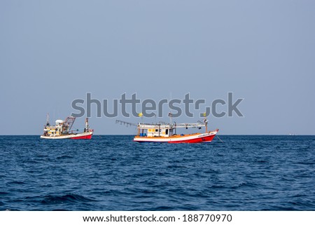 KRABI,THAILAND-MARCH 28,2014:The Old fishing boats running in the Andaman sea of Phi Phi island bay in Krabi Thailand.