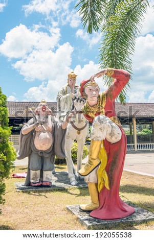 KRABI, THAILAND MARCH 30, 2014 : Chinese statue a priest and members of \