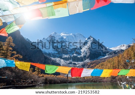Sunlight  with prayer flag and  snow mountain
