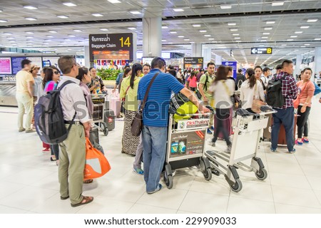 Bangkok,Thailand-October 01,2014 :  Passengers looking the baggages at baggage claim area  at international arrival  terminal in Suvarnabhumi Airport in Bangkok.