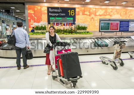 Bangkok,Thailand-October 01,2014 :  Passengers looking the baggages at baggage claim area  at international arrival  terminal in Suvarnabhumi Airport in Bangkok.