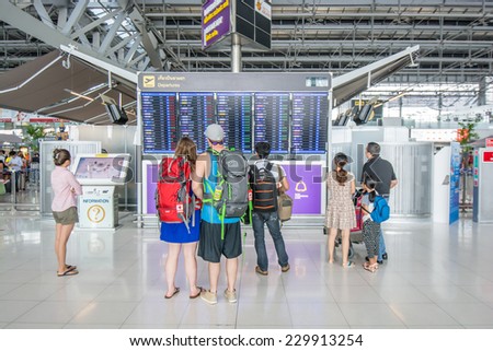 Bangkok,Thailand-August 31,2014 : Unidentified passengers look at the departures board at Suvarnabhumi International Airport in Bangkok ,Thailand.
