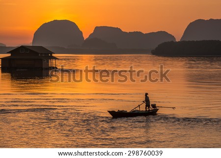 Phang-Nga Thailand - April 18,2015 : Thai fisherman on local fishing boat at Samchong fishing village on sunrise in Phang-Nga,Thailand.