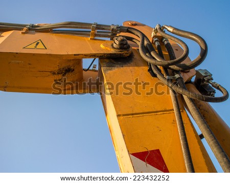 Hydraulic connections hoses of a machinery industrial detail. Excavator arm