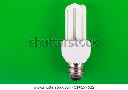 Energy saver bulb over green background