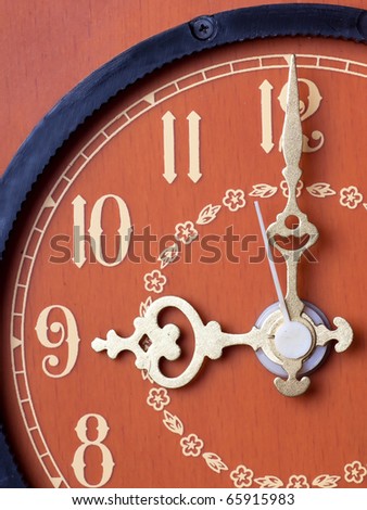 Closeup view of antique clock face. Nine o`clock.