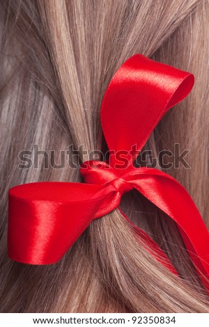 Closeup view of red bow in a woman hair